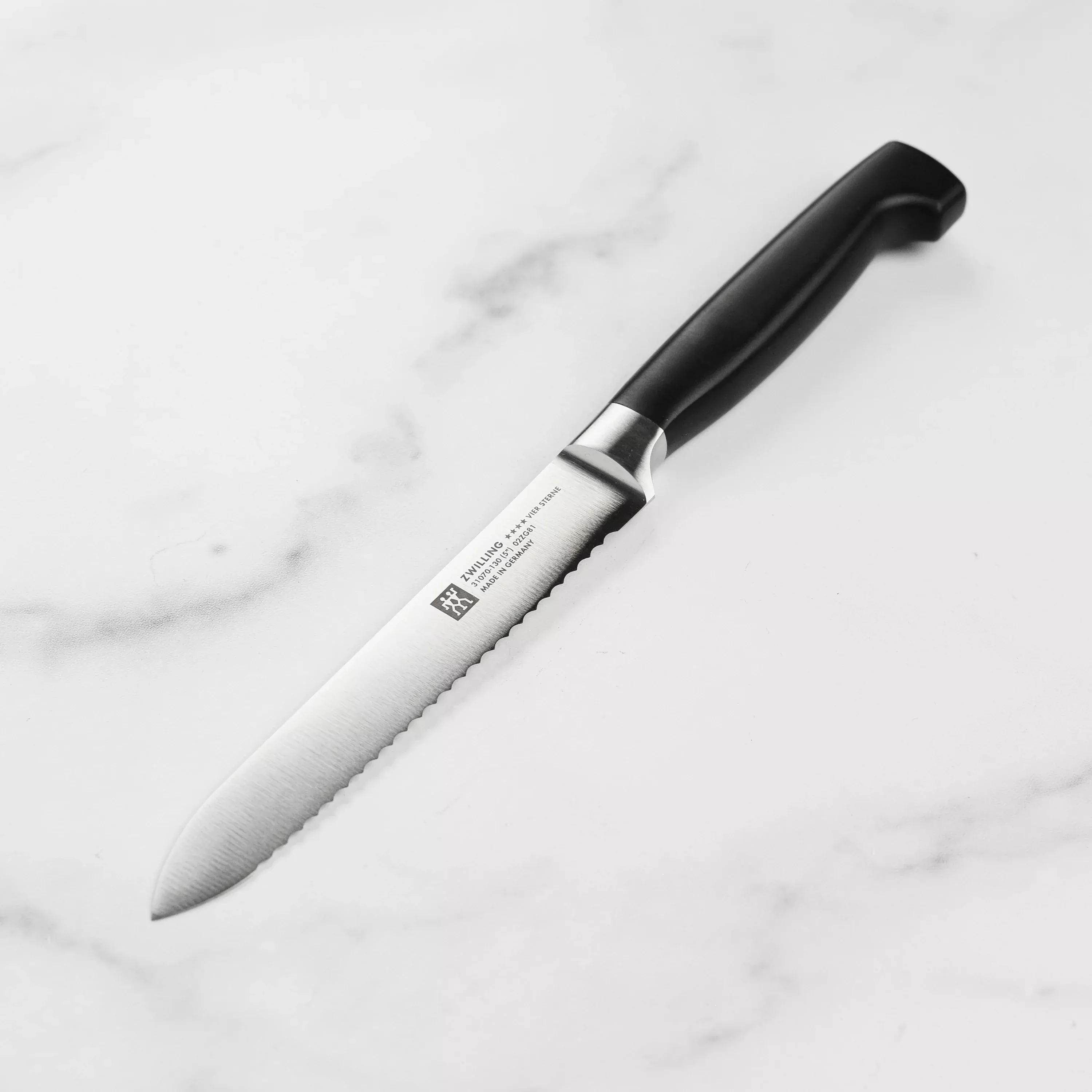 zwilling-j-henckels-four-star-serrated-utility-knife-5 Zwilling J.A. Henckels Four Star Serrated Utility Knife - 5"